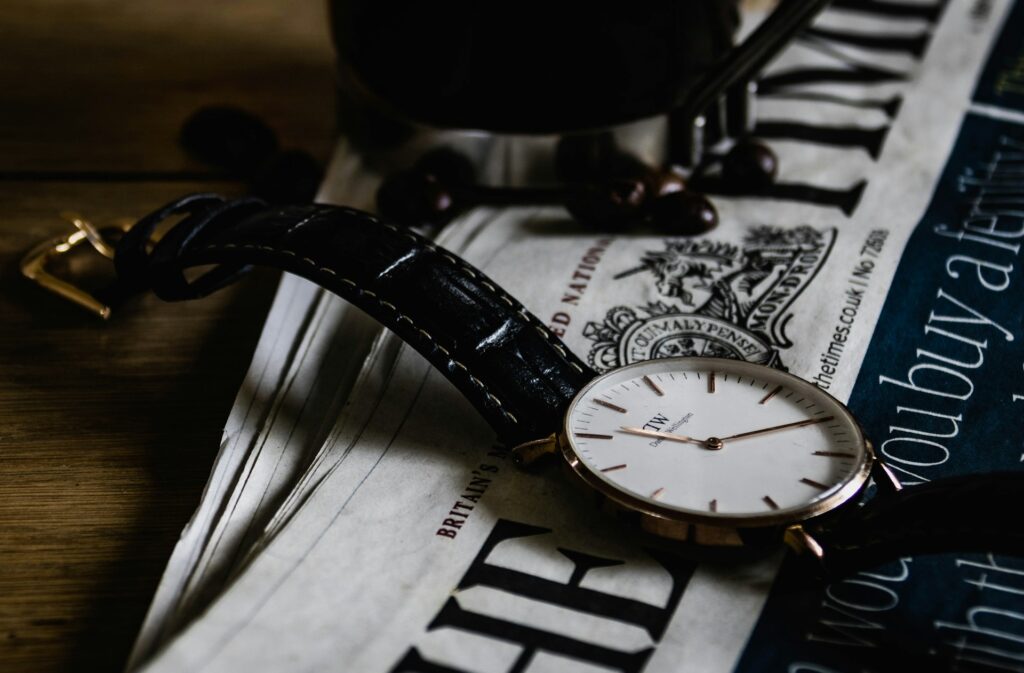 watch on newspaper to symbolize the value of being on time