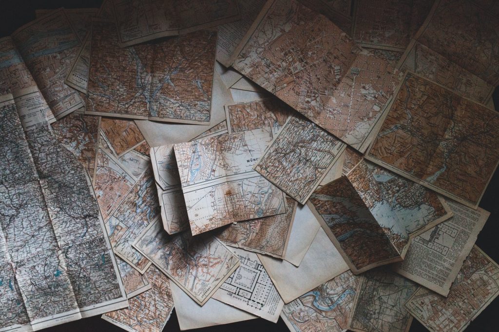 A variety of old maps scattered around a surface