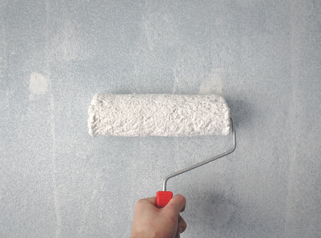 a white paint roller on a wall
