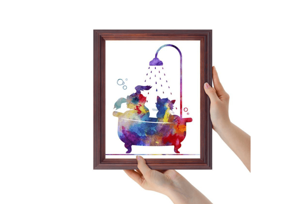 a woman holding a framed photo of colorful pet art
