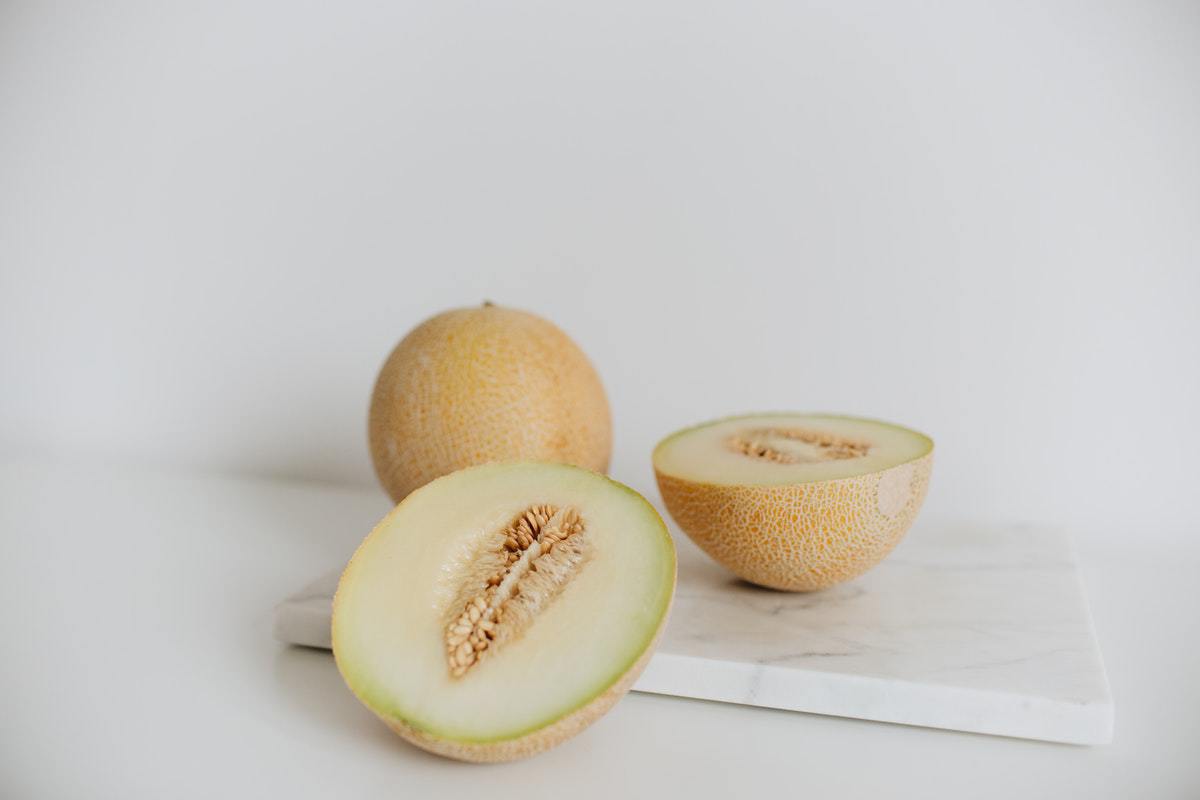 a sliced open cantaloupe on marble