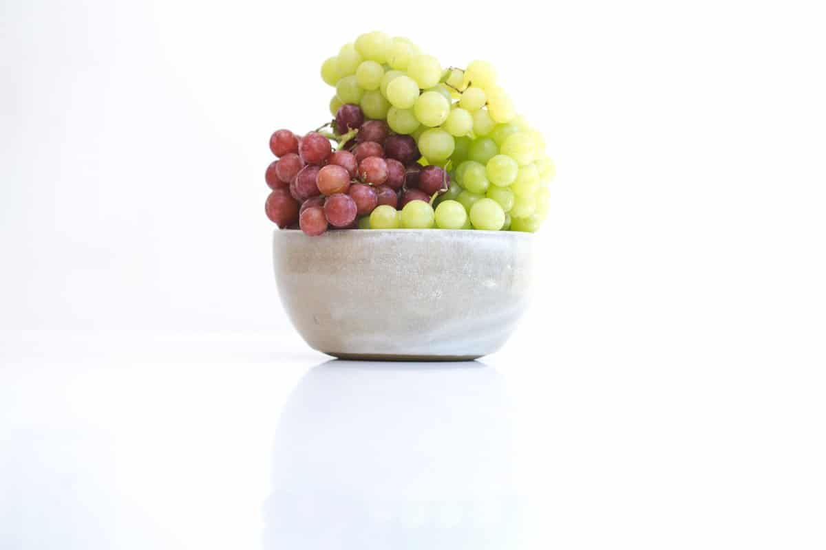 a ceramic bowl of grapes