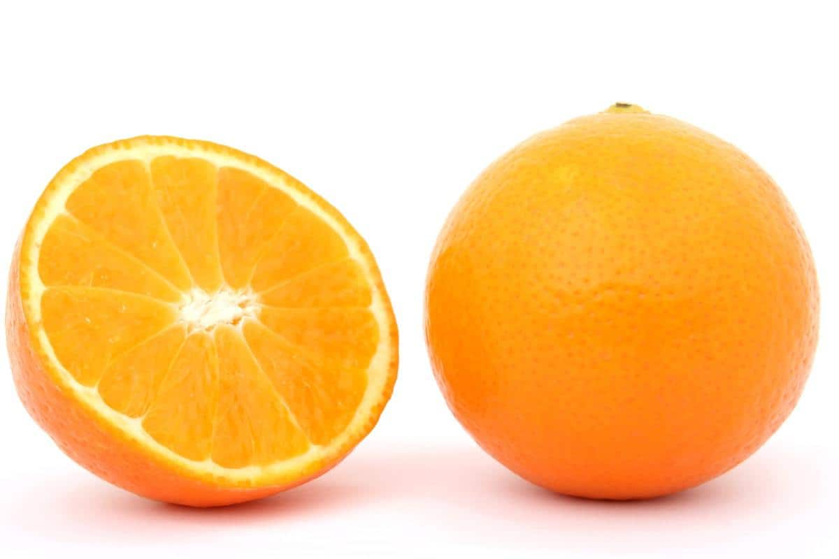a whole orange and a sliced half orange
