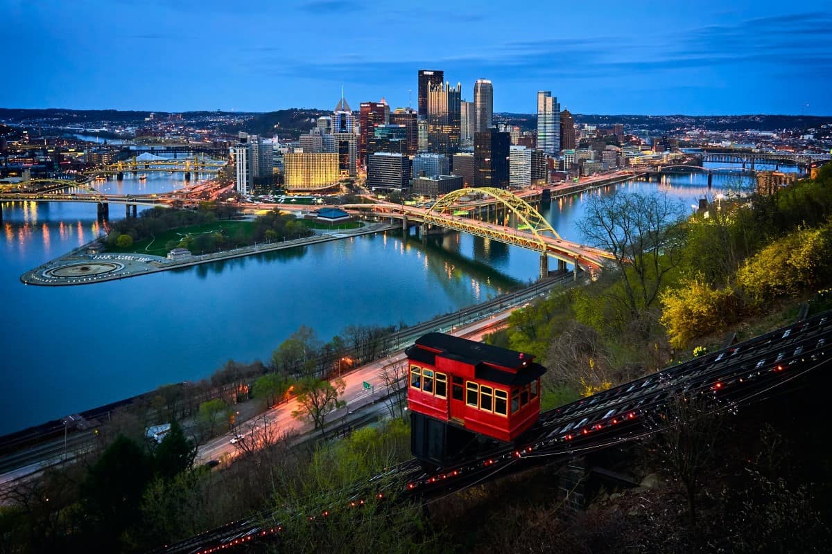pittsburgh incline plane over river with yellow bridge