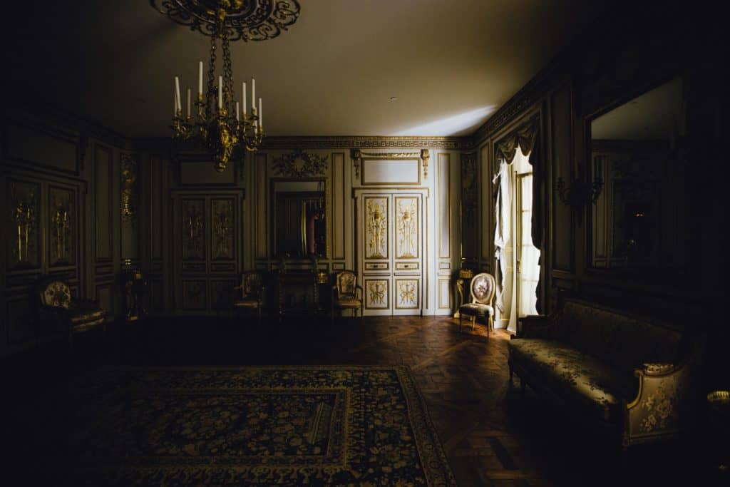a dimly lit grand Victorian sitting room