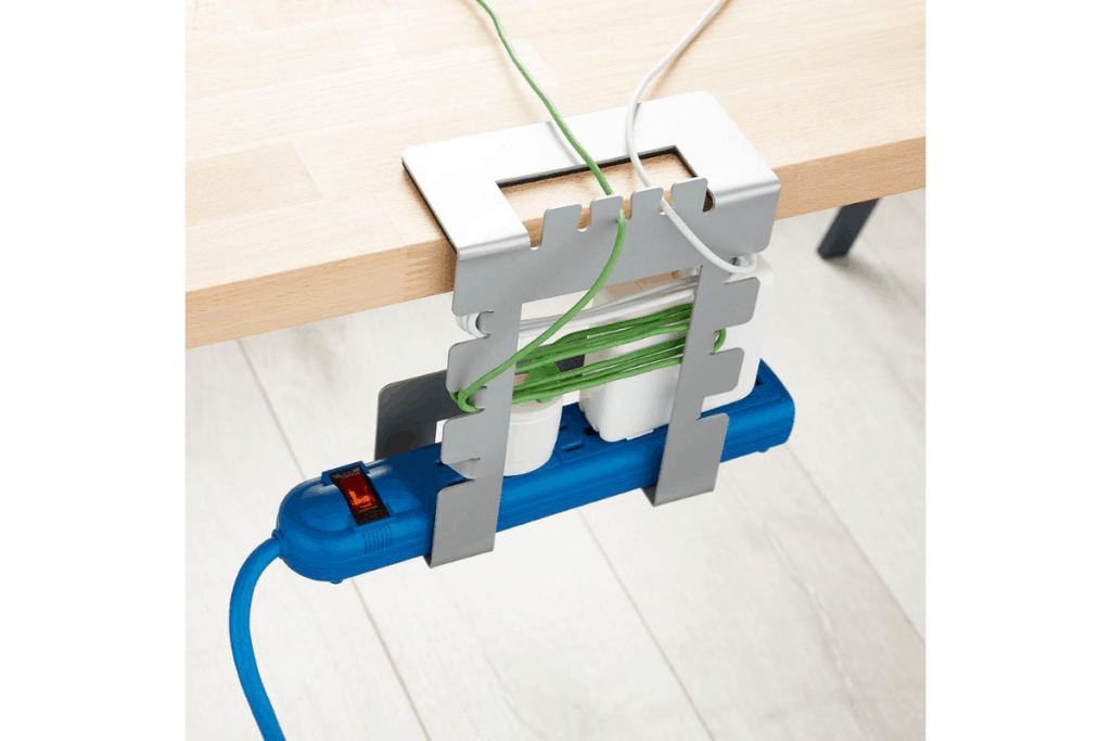 a white cord organizer that clamps onto a desk