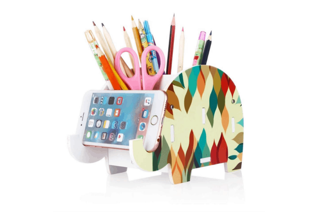 a colorful, geometric elephant pencil and phone holder