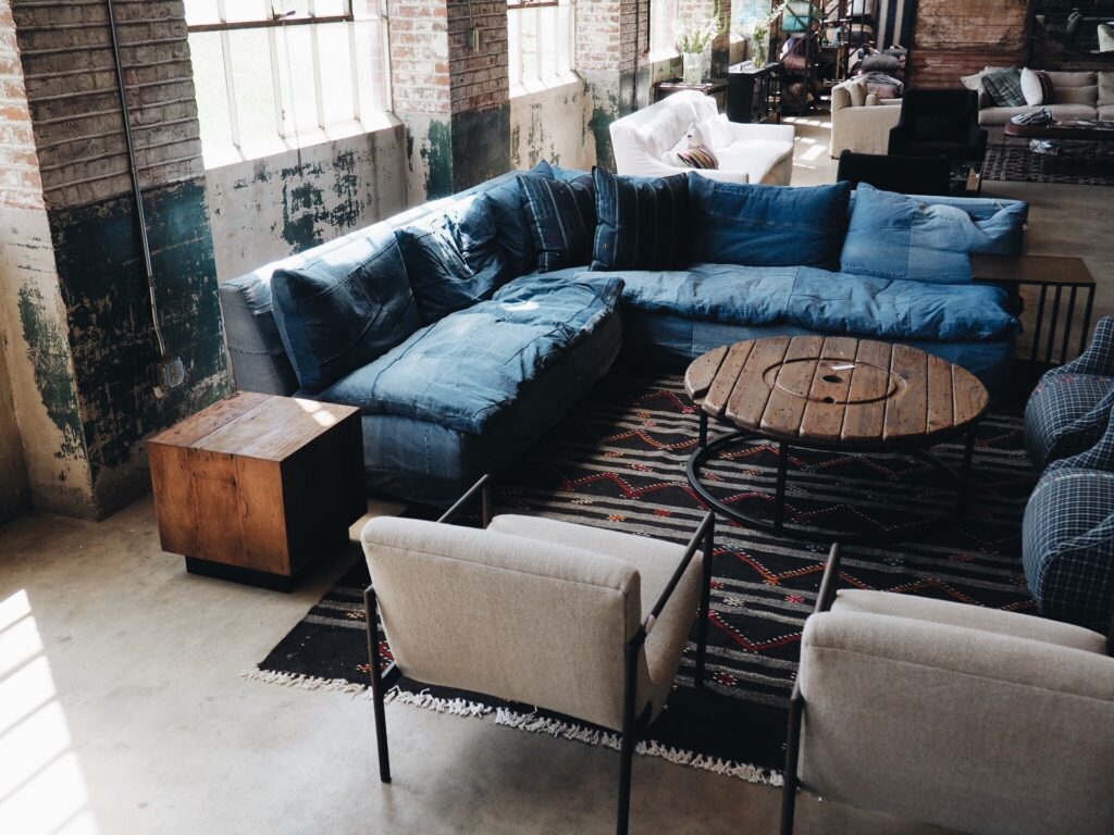 industrial living room with a concrete floor and a rug