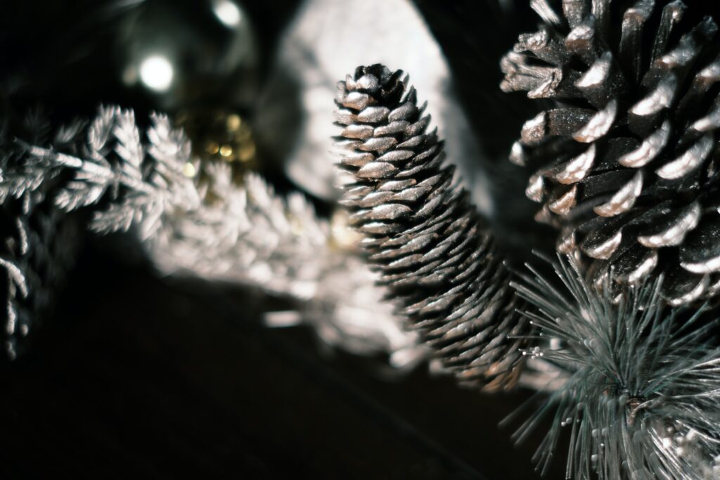 silver glittery pinecones on a tree