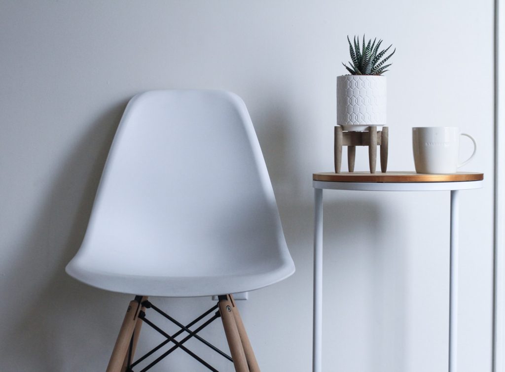 a minimalist white chair & side table