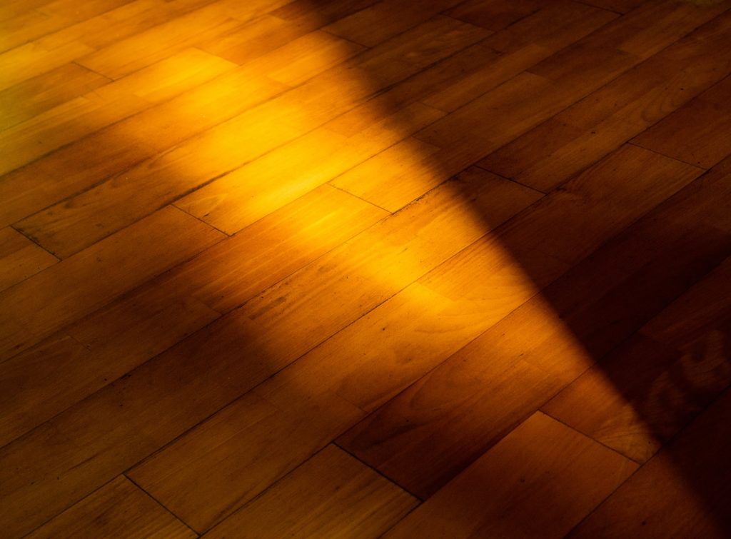 light, hardwood flooring with a streak of light