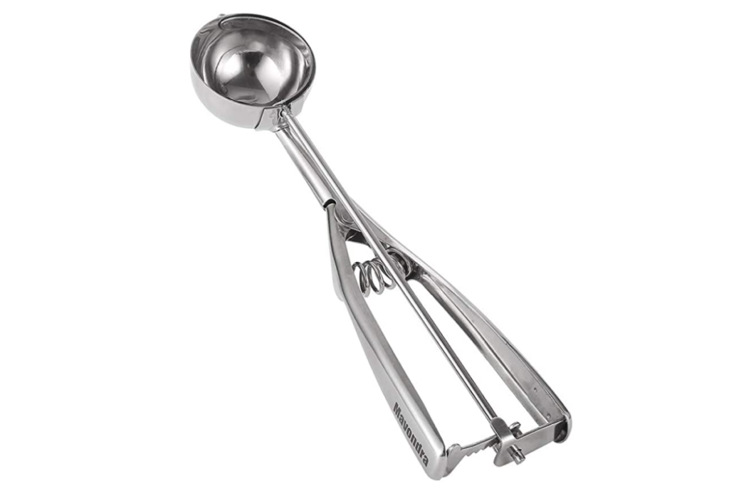 A silver cookie scoop with "mavondra" written on the handle