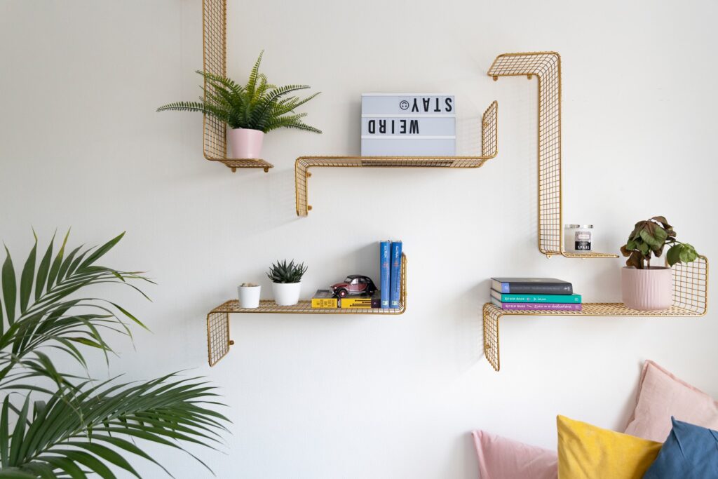 golden angled shelving hanging on wall to free up space