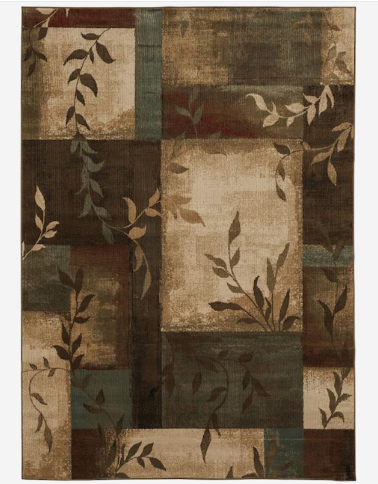 a brown geometric rug with leaves on it