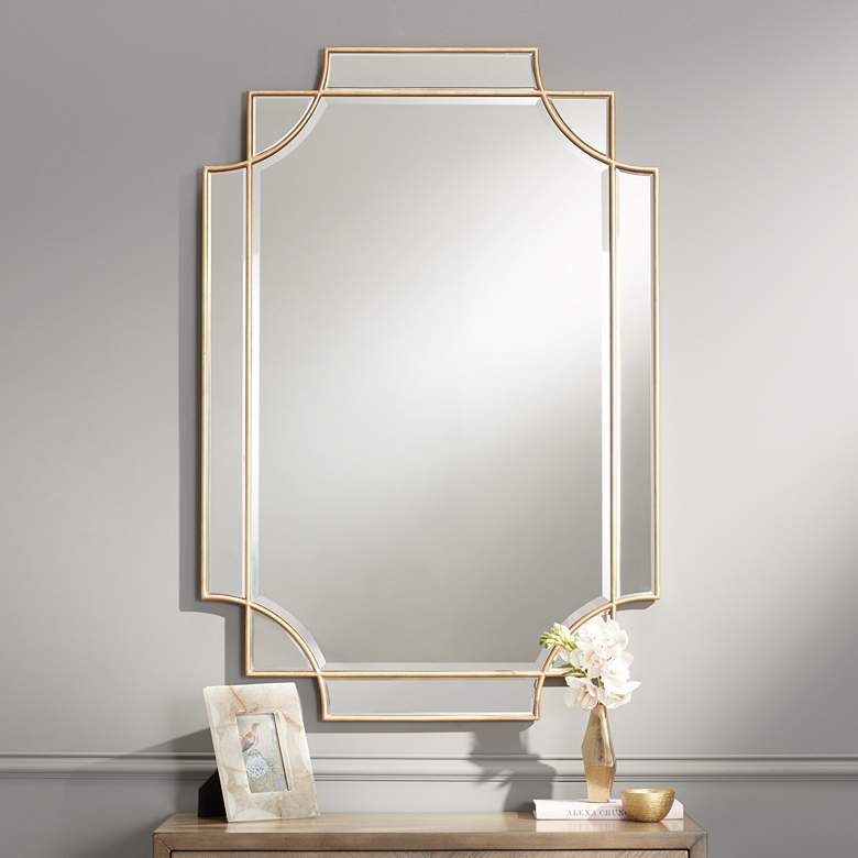 a gold rimmed geometric mirror
