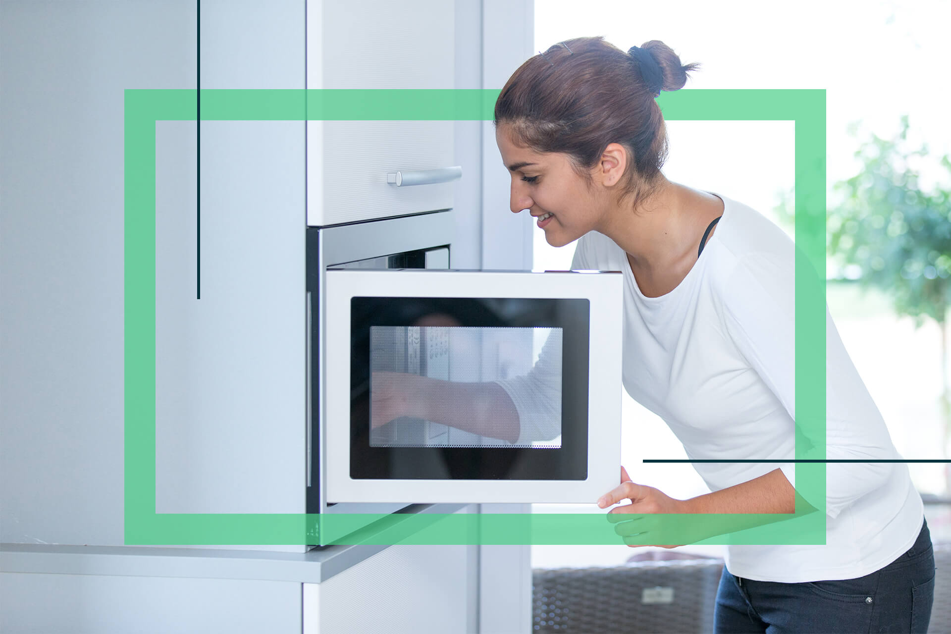 a woman cleaning a small microwave