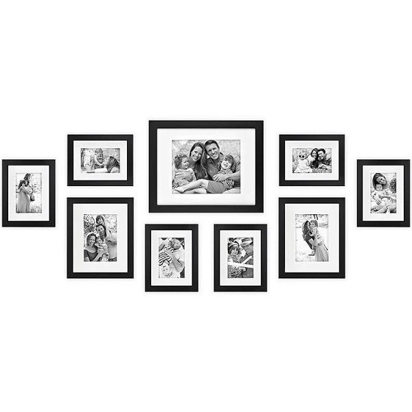 a black framed gallery wall with black and white photos