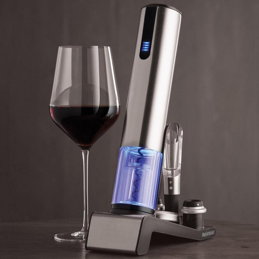 an electric wine opener with a glass of red wine next to it