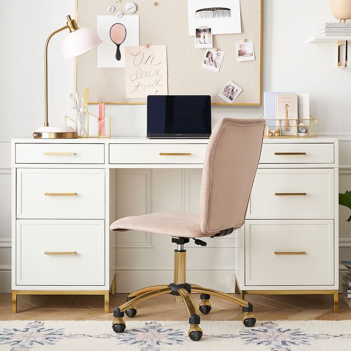 a white desk with many drawers and office supplies