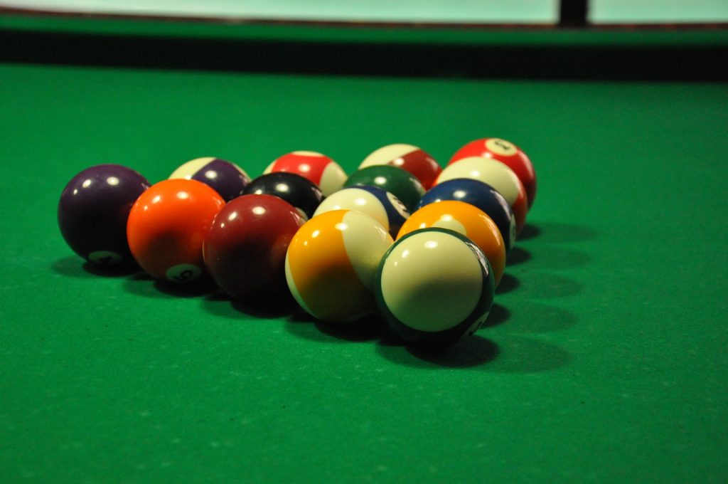 an up close image of pool balls set up on a pool table