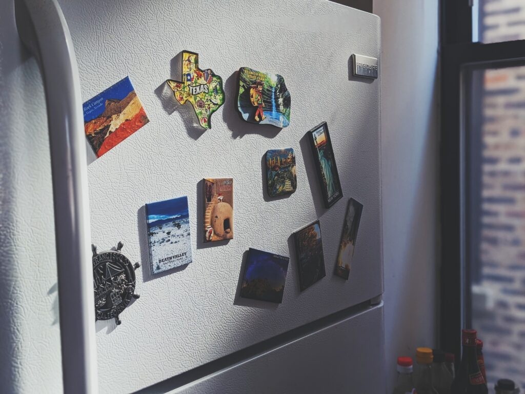 upclose image of a white fridge with magnets