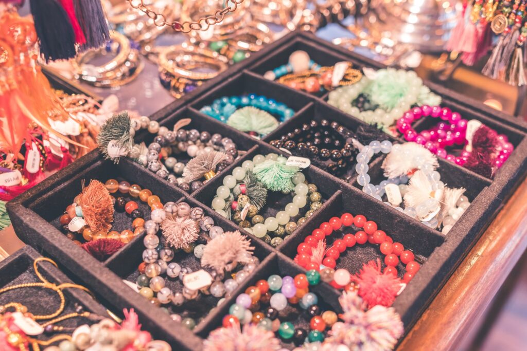 a variety of colorful jewelry in divider boxes