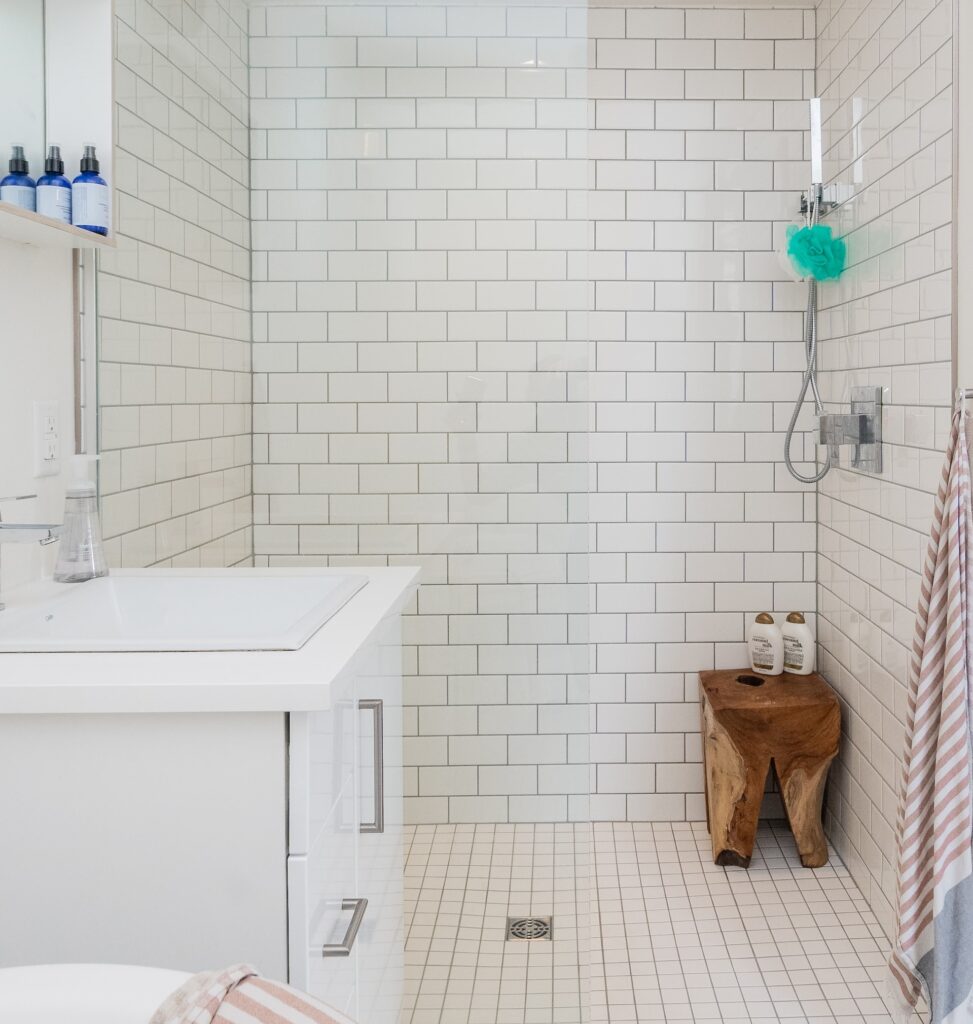 an open white tiled shower stall 