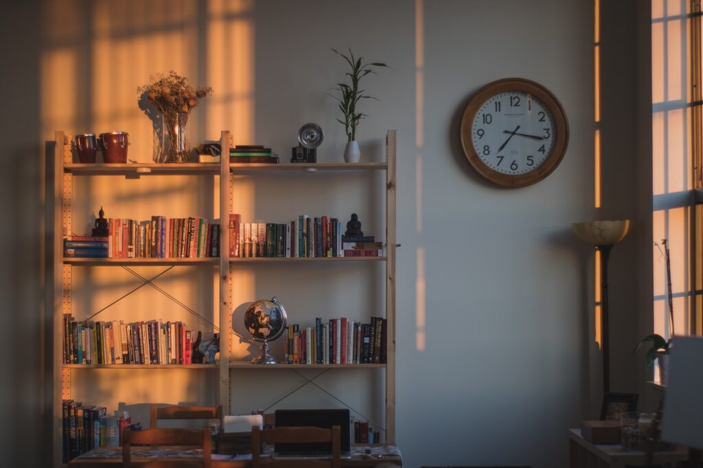 a bookshelf with knickknacks in need of decluttering to simplify your life