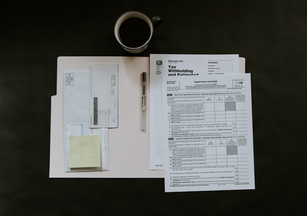 tax documents in a folder with a coffee cup