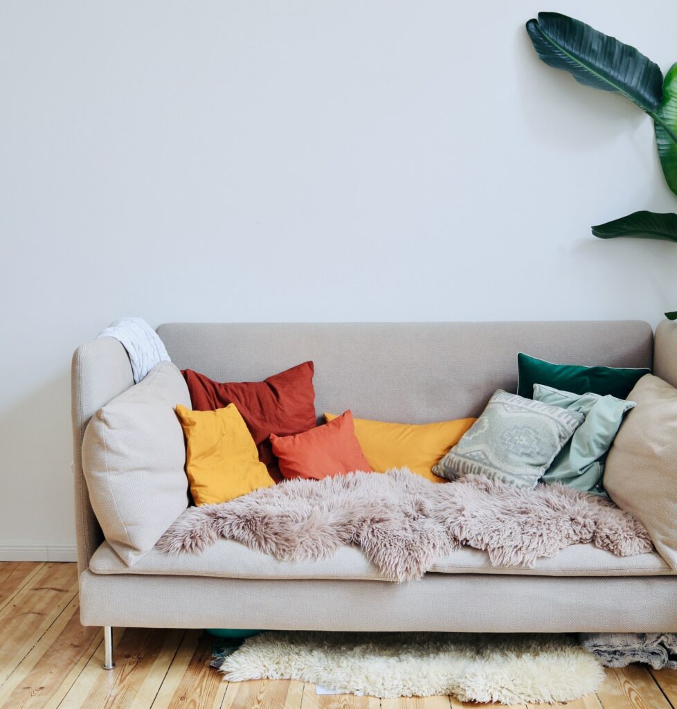 a grey couch with colorful pillows