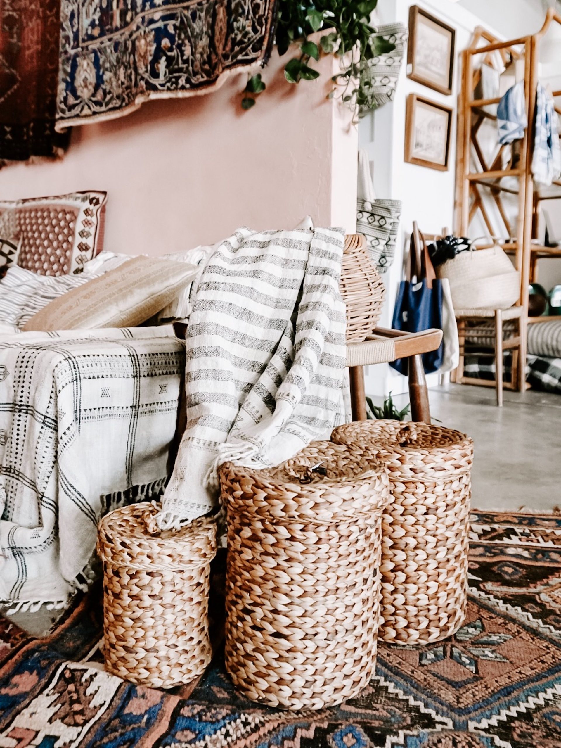 A boho decorated living room with three baskets used for storage
