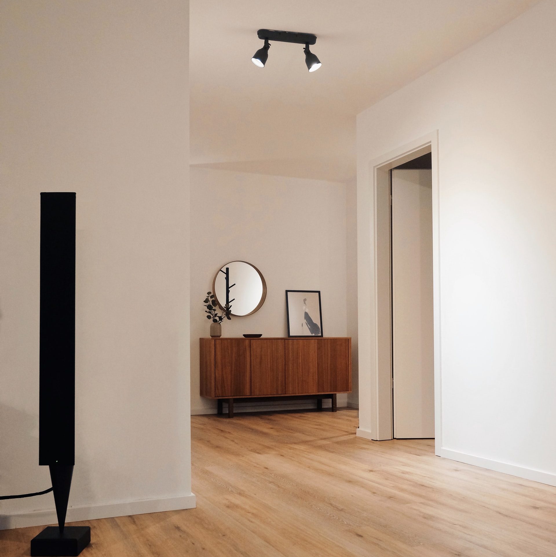 A minimalist room with black track lighting