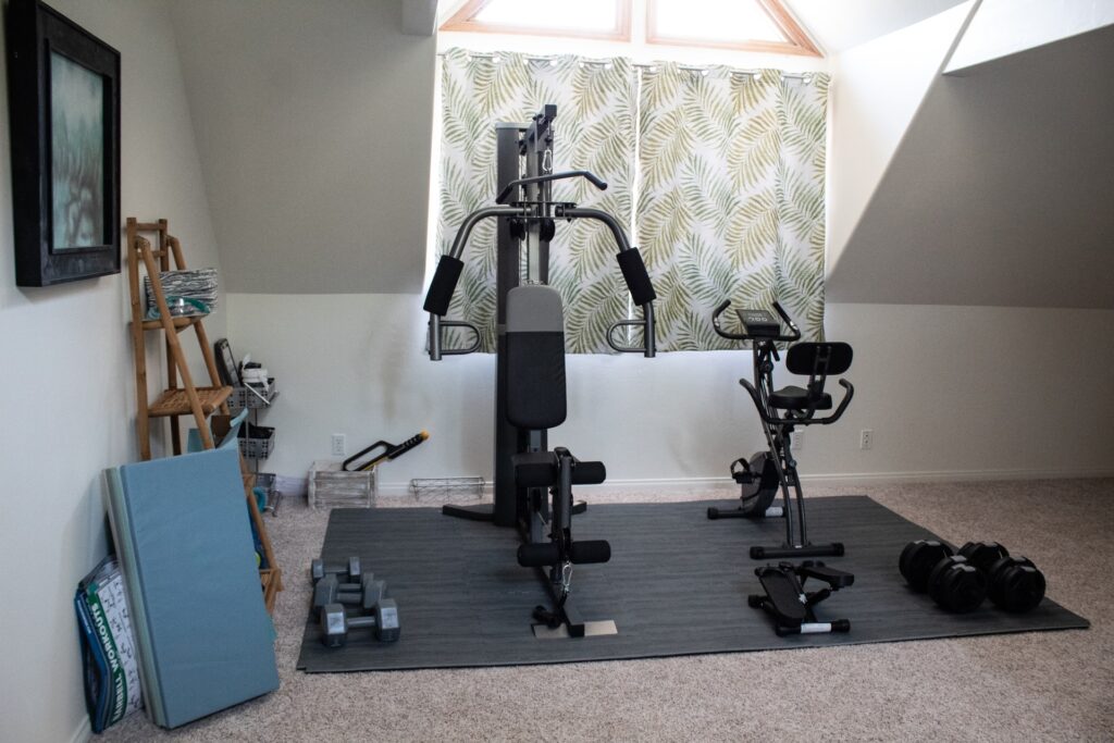a variety of gym equipment in a room