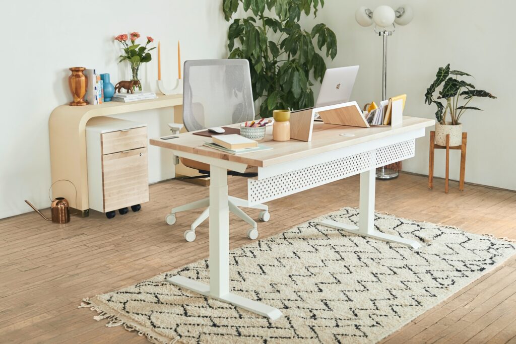 a simple. neutral home office with a desk and an endtable