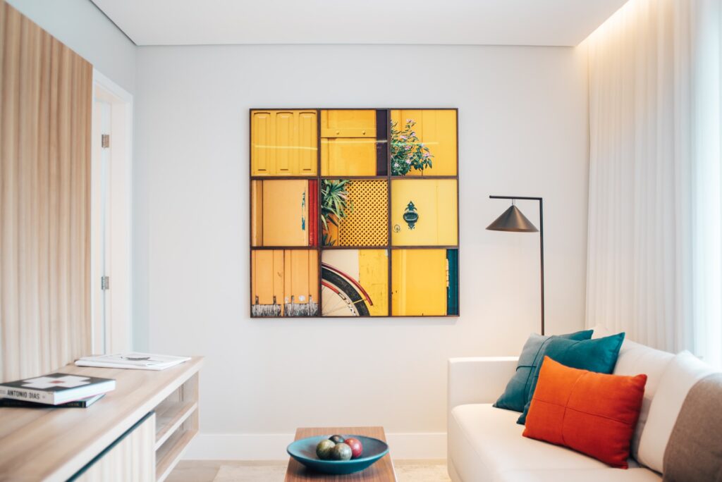 a yellow grid of 3x3 art hanging on the wall