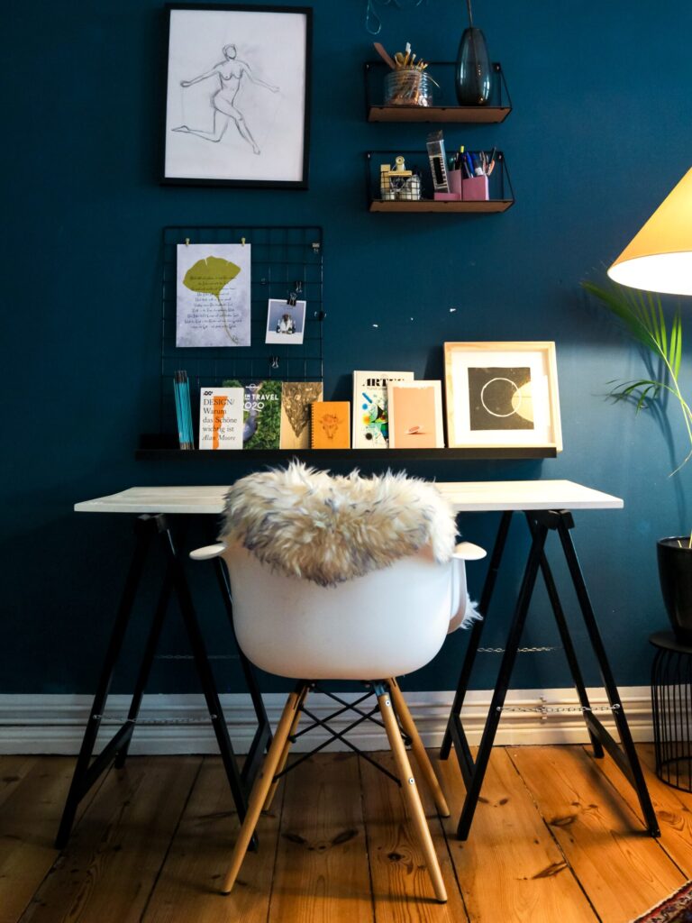 an organized home office with a blue wall