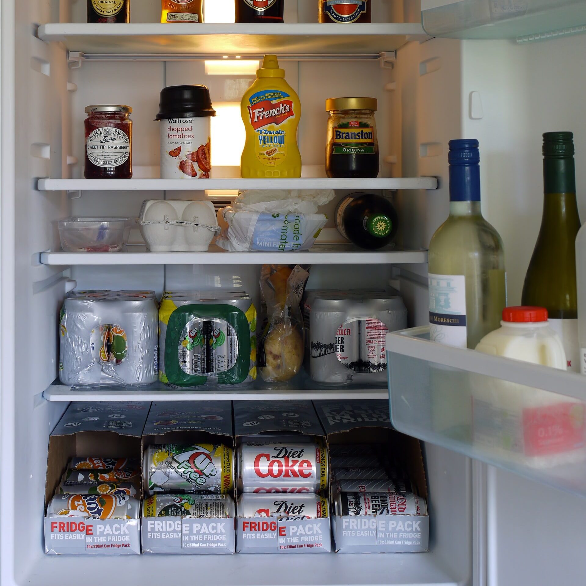 organized beverages and condiments in a fridge