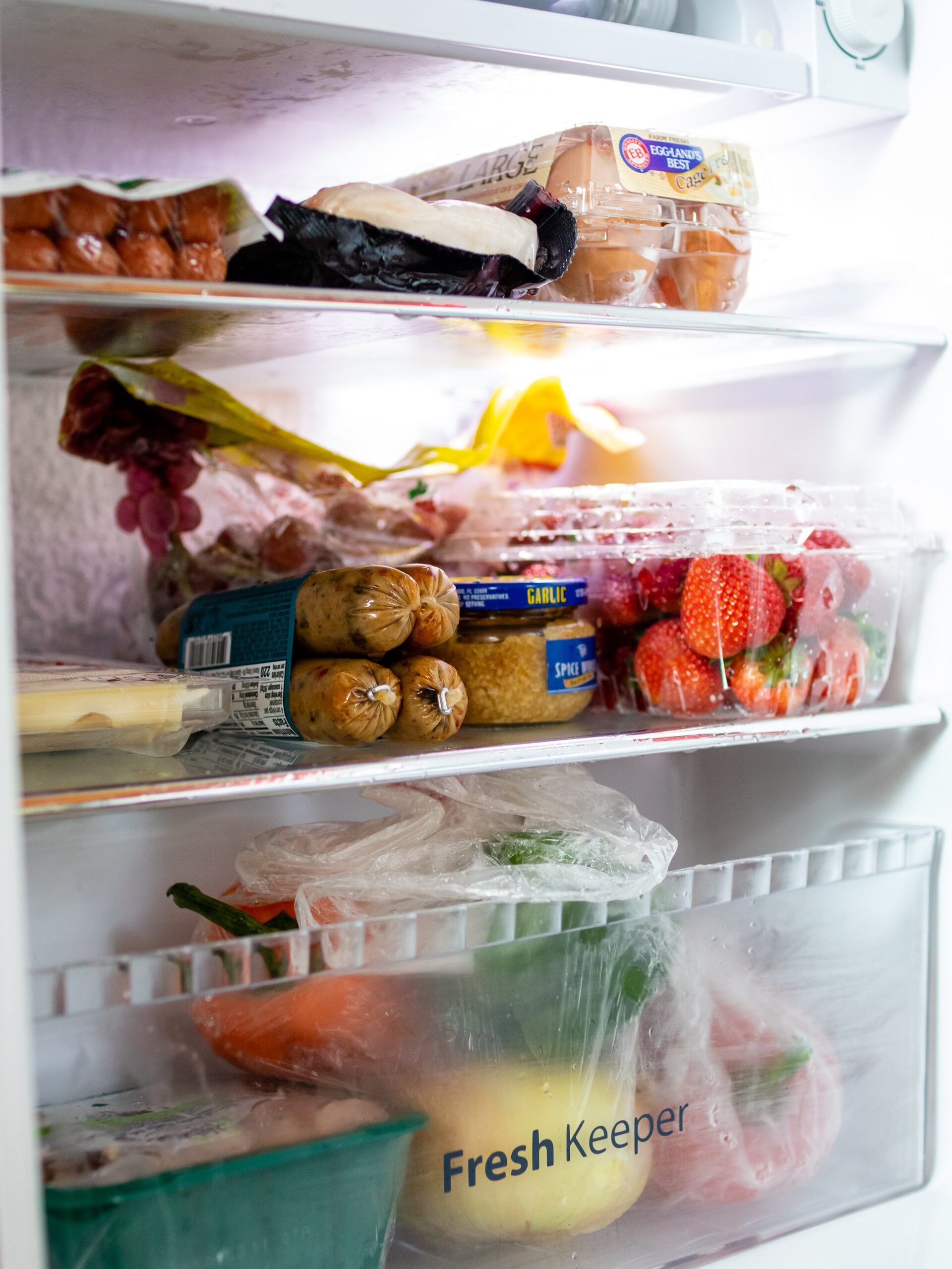 a variety of fresh foods organized in the fridge