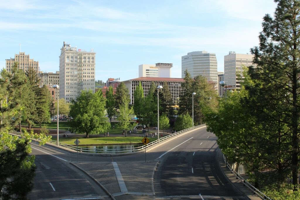 A road in Spokane, Washington with tall buildings in the background