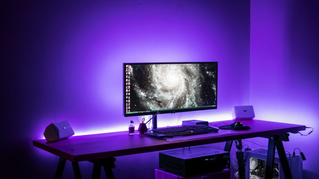 a computer backlit with purple light