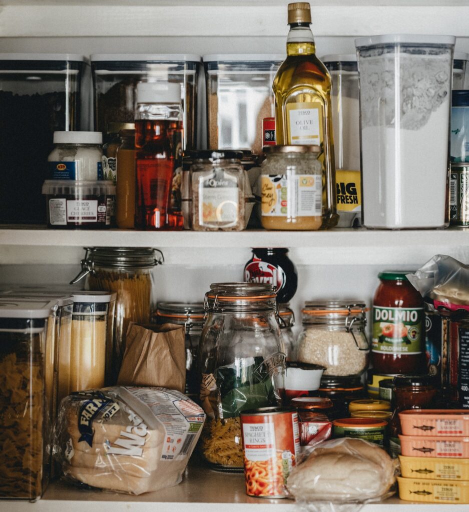 a pantry shelf full of food to be sorted through