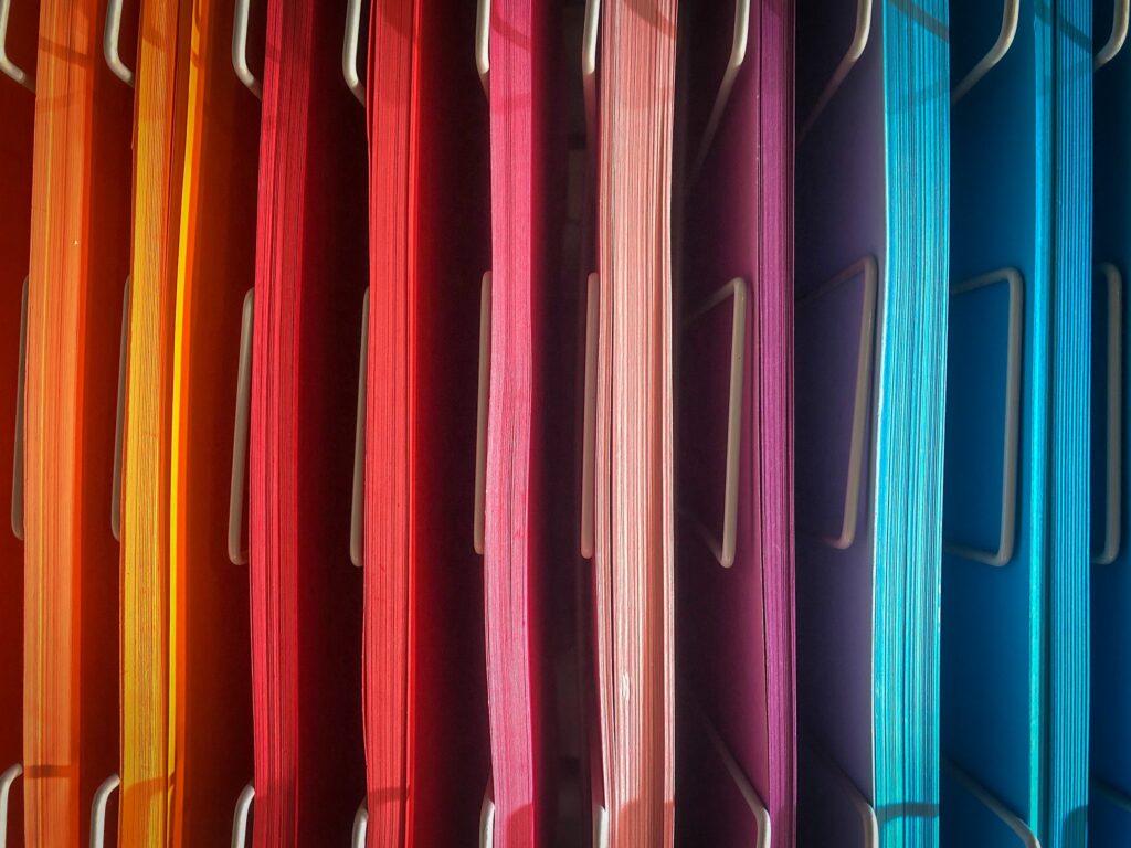 colorful papers in a metal file organizer