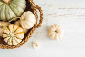 decorate with pumpkins by adding them to a basket