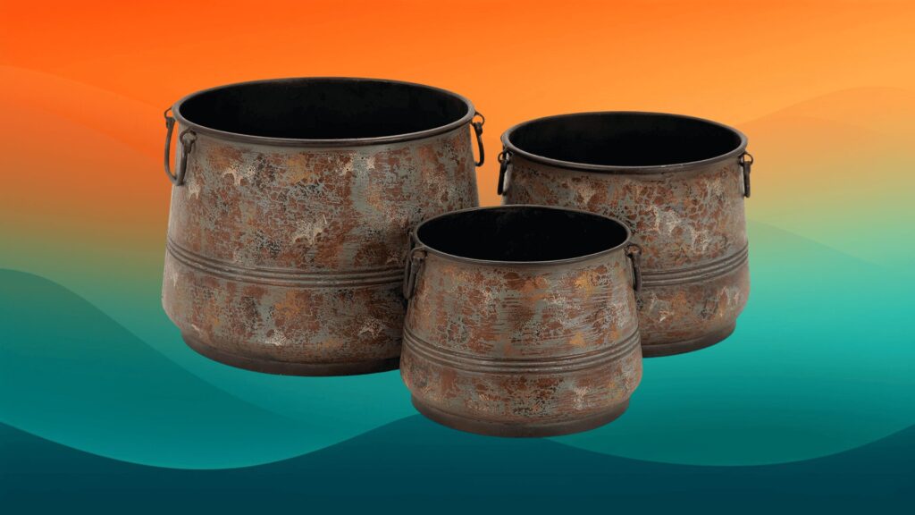 three rustic metal planters in front of an orange and teal background