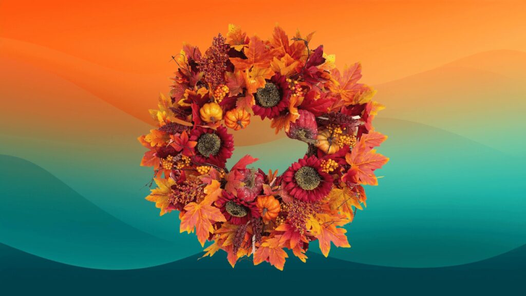 fall wreath with flowers, leaves, and pumpkins in front of an orange and teal background to decorate your porch for fall