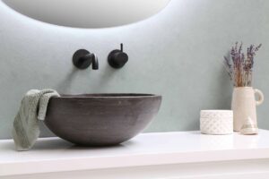 close up of a minimal sink and counter demonstrating how to make a small bathroom look like a spa