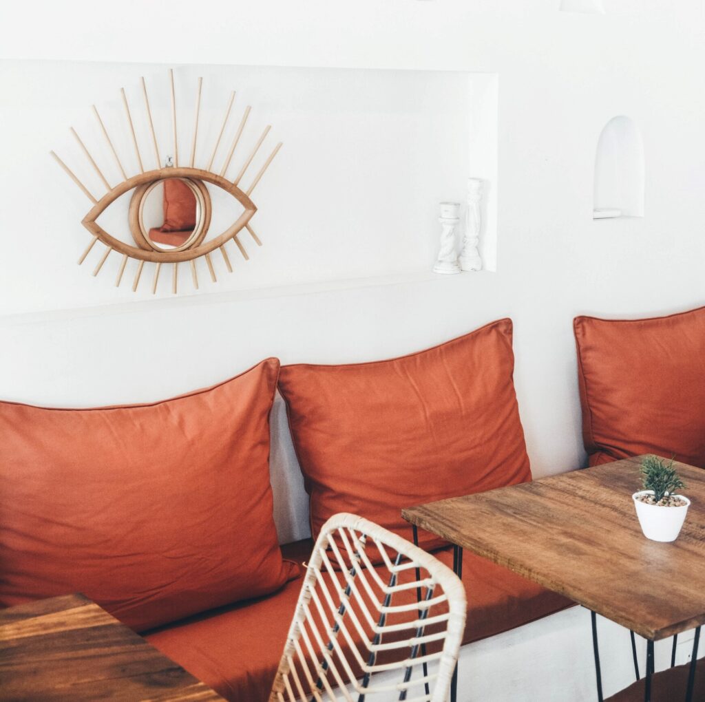 a white room with orange accent pillows