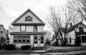 a greyscale home exterior hiding the truth about buying a foreclosed home