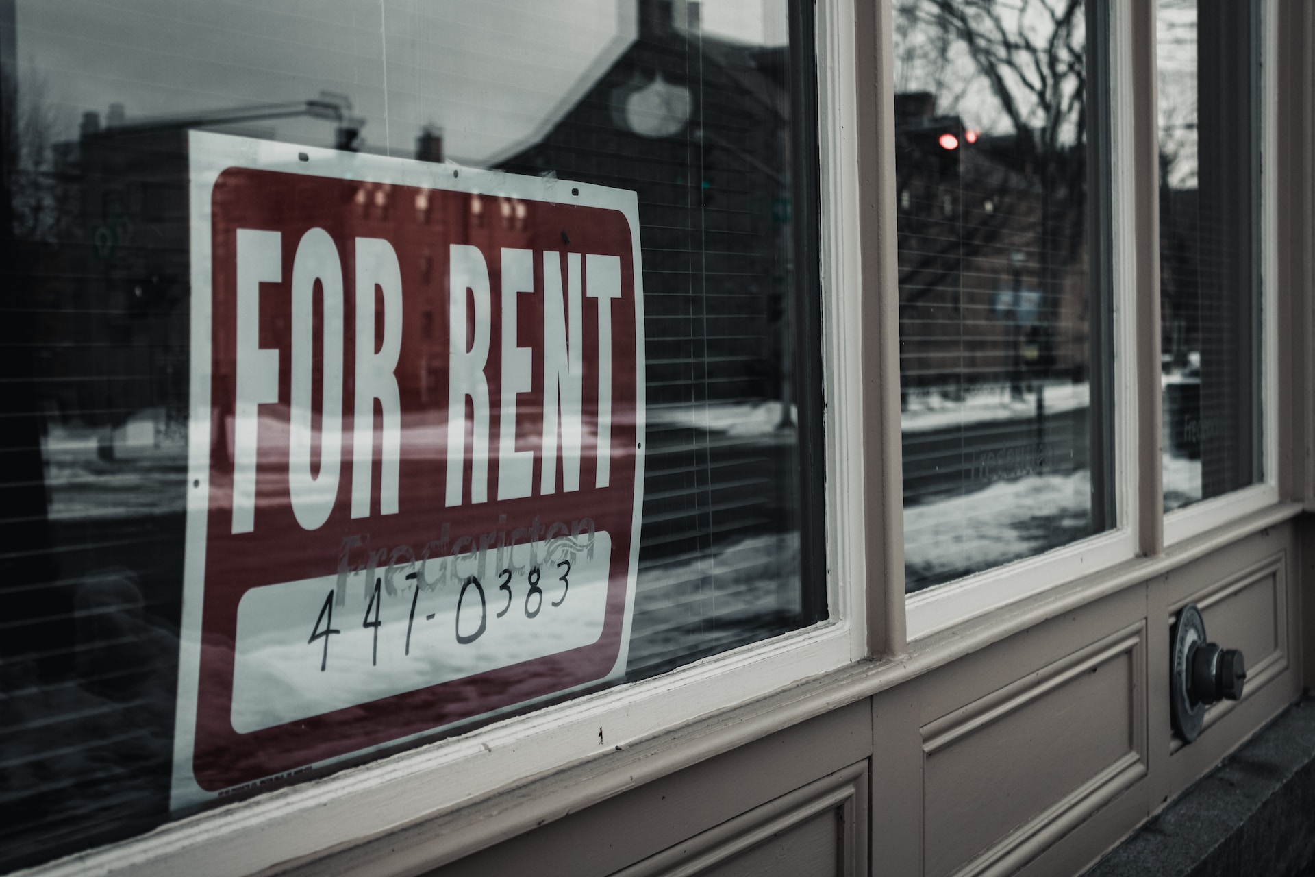 "For rent" sign in a window.