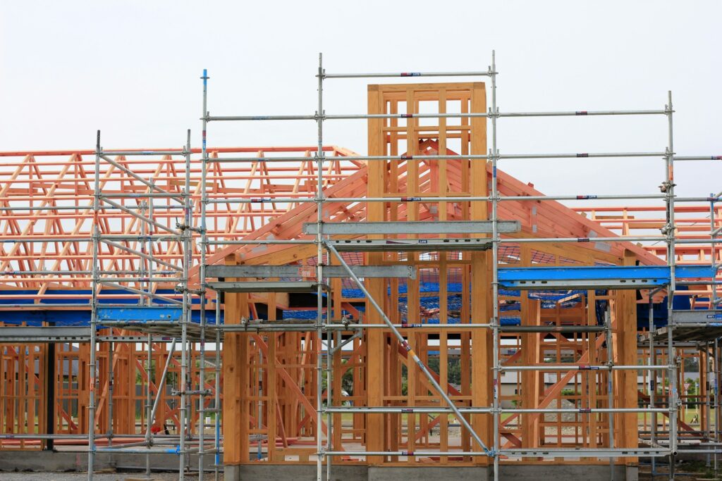 A home's frame is going up under a cloudy sky, likely in one of the cheapest states to build a house.